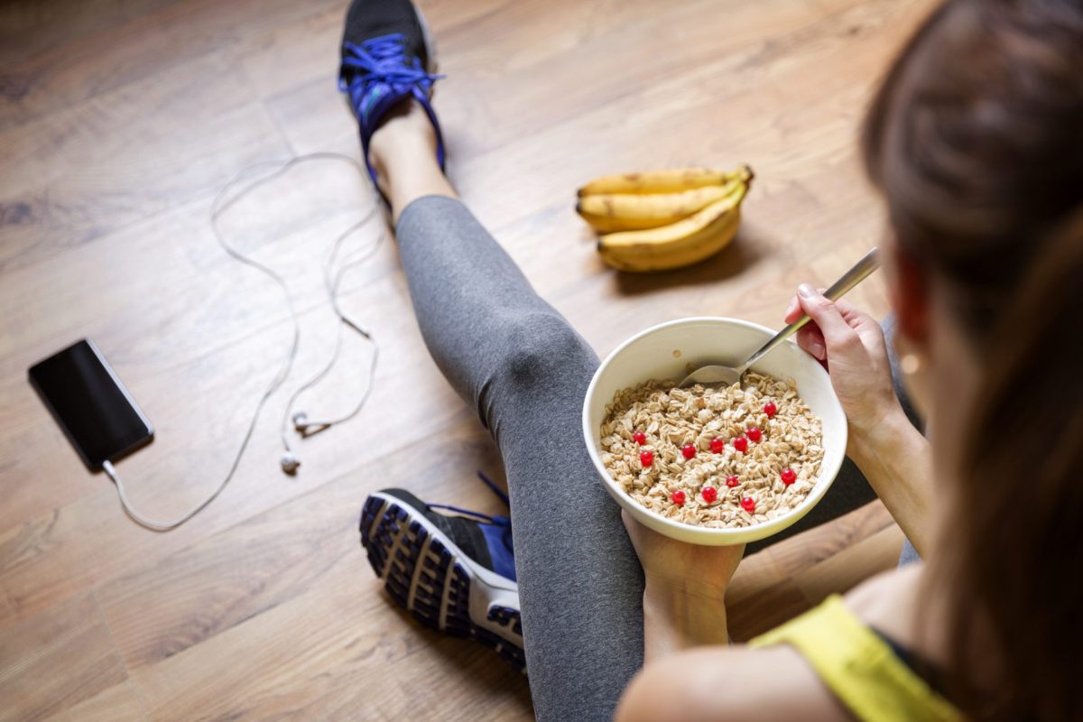 Frau isst Haferflocken mit Obst Sport