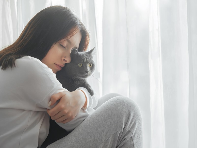 Frau kuschelt mit Katze