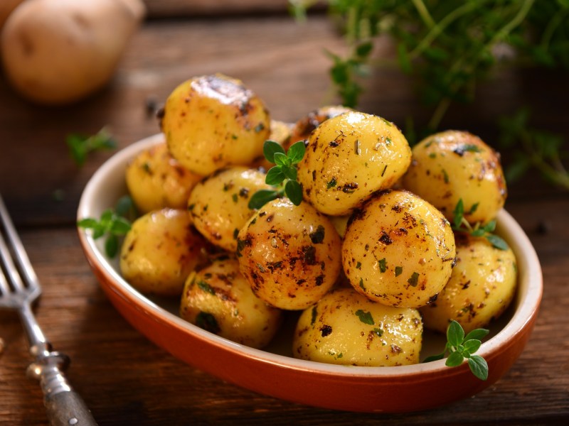 Thymian-Zitronen-Kartoffeln in einer Auflaufform, daneben eine Gabel.