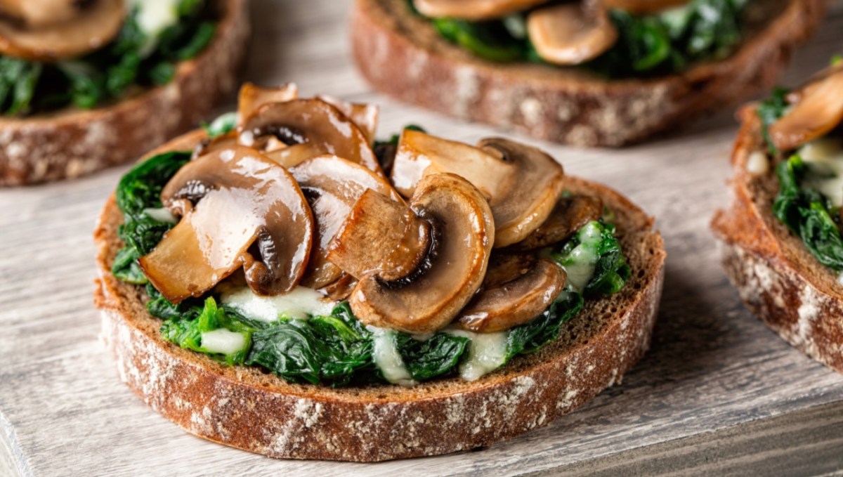 Mehrere Portionen Champignon-Bruschetta mit Ricotta und frischen KrÃ¤utern.